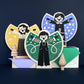 Wooden Screen Printed Angels by The Print Lass - a green, gold and lilac angel standing on pale wood blocks on navy background